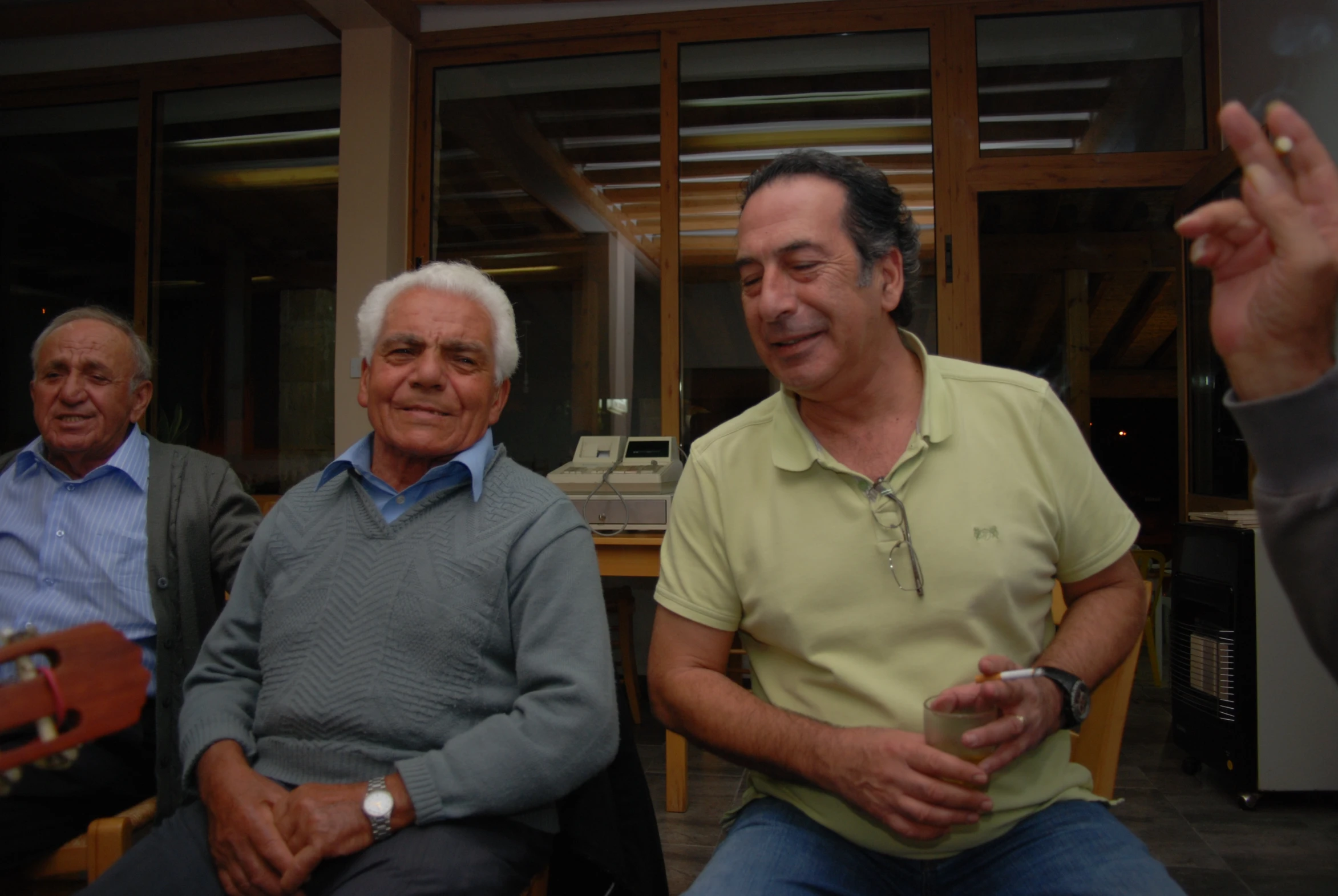 several elderly men sitting together and clapping