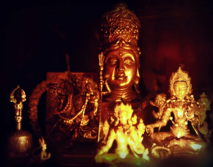 a buddha statue surrounded by other ornate items