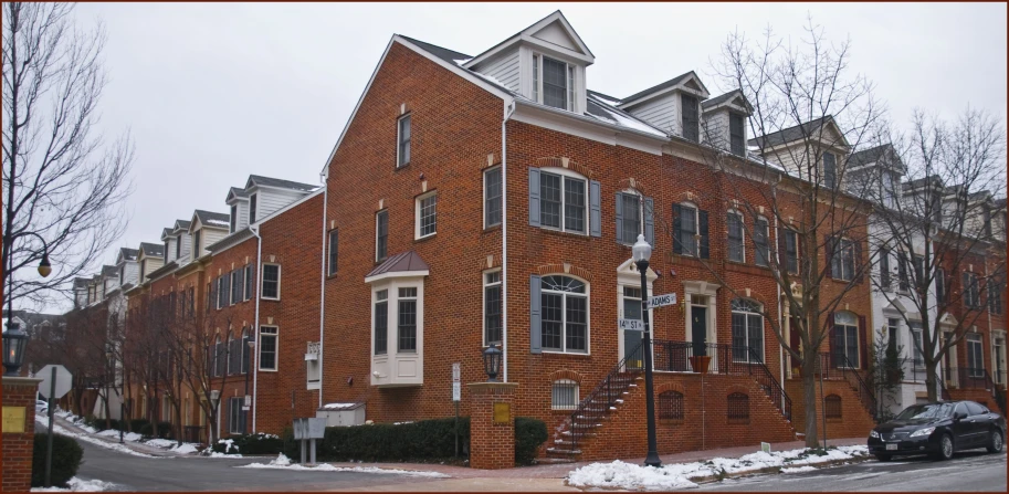 an old brick building is surrounded by snow and trees