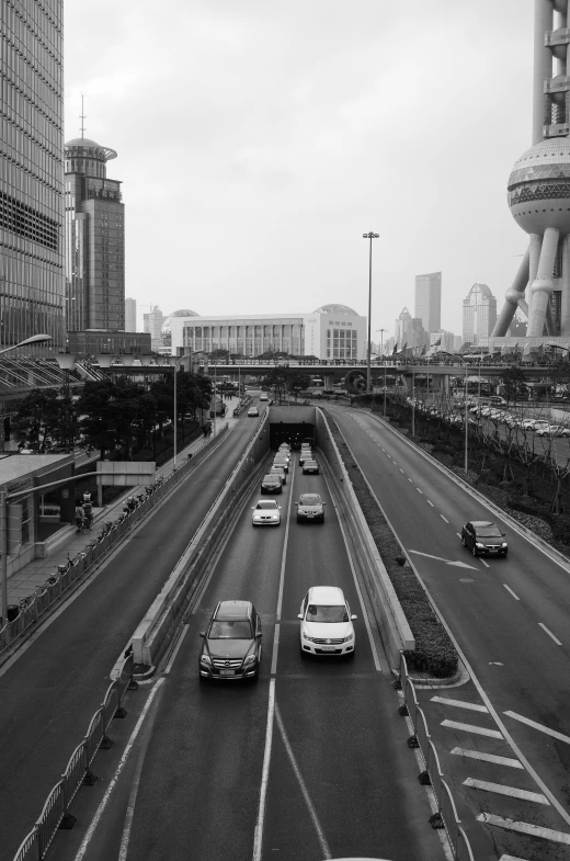 cars driving down a highway in the city