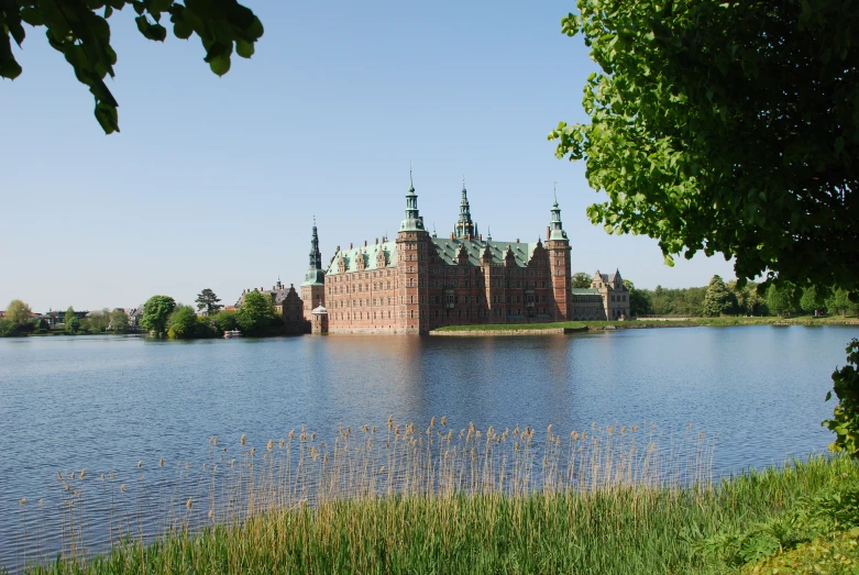 a very large castle sitting on top of a lake