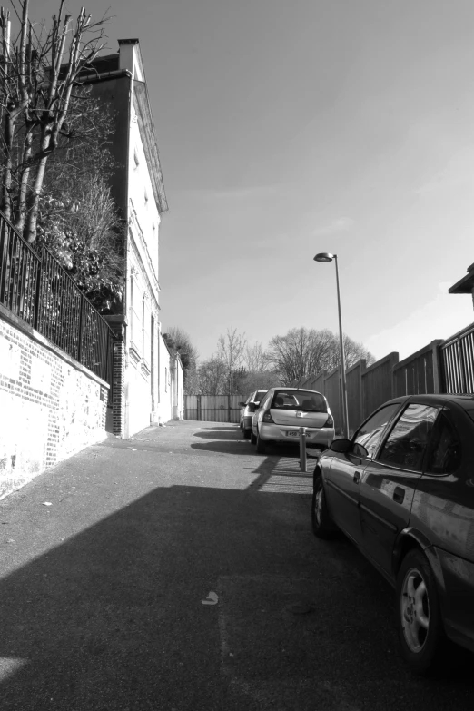 a group of parked cars sitting on the side of a road