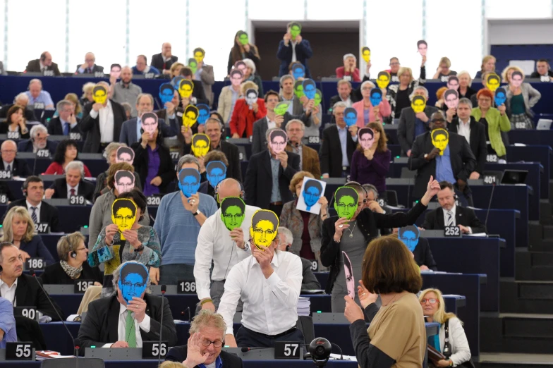 a group of people at a convention wearing masks with faces painted on them