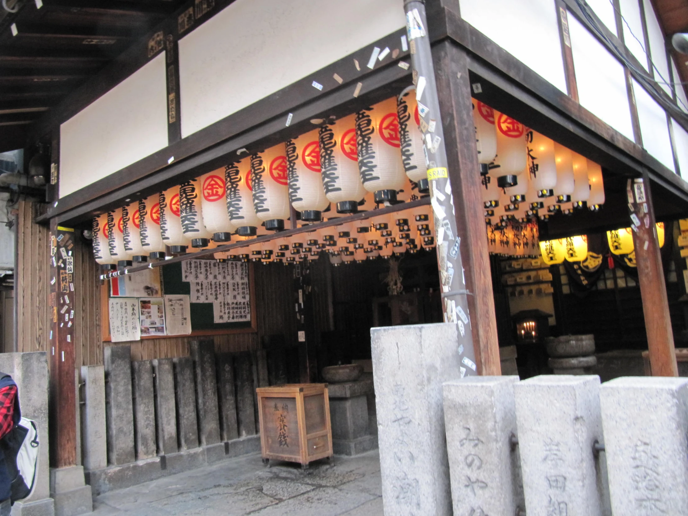 a woman standing under a hanging lantern and decor