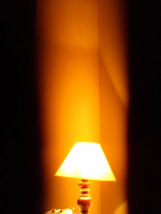 a lamp that is on the side of a bed