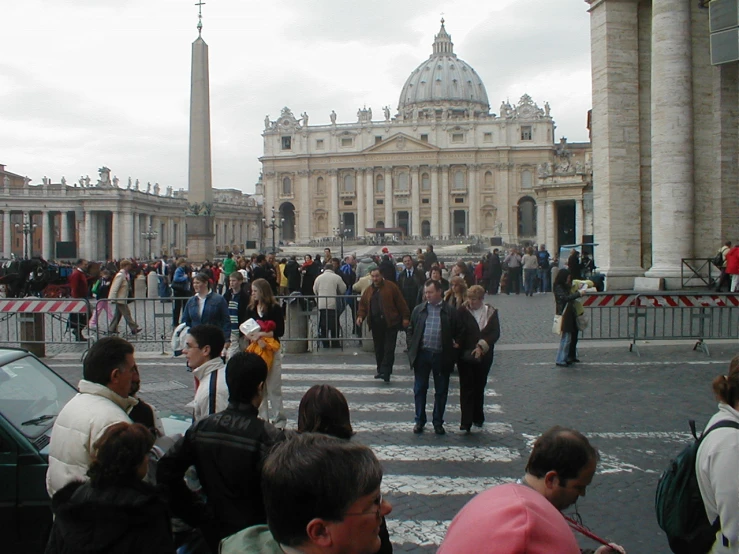 many people and vehicles are gathered on a street