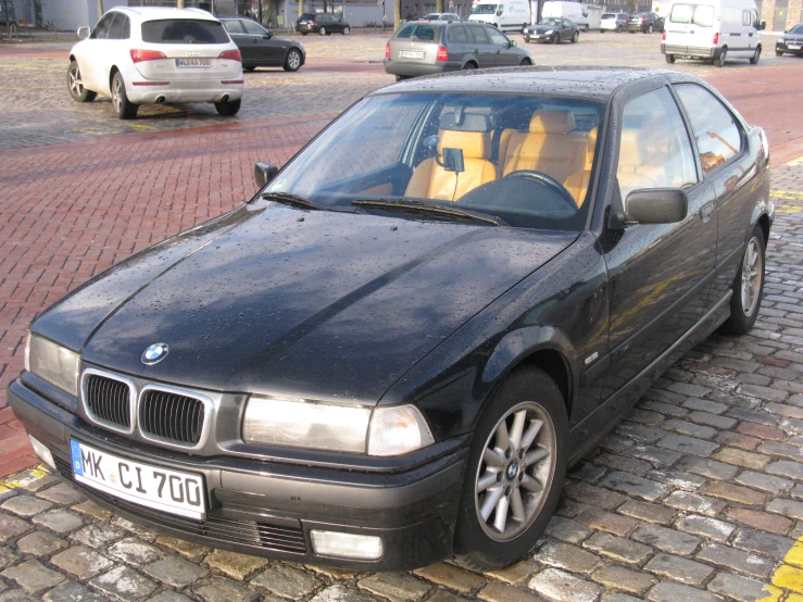 a black bmw parked on the side of the road