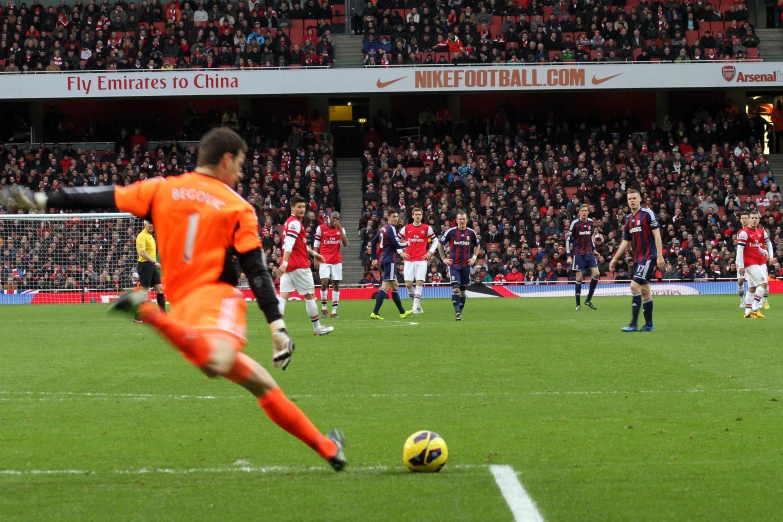 a soccer player kicks the ball while other players look on