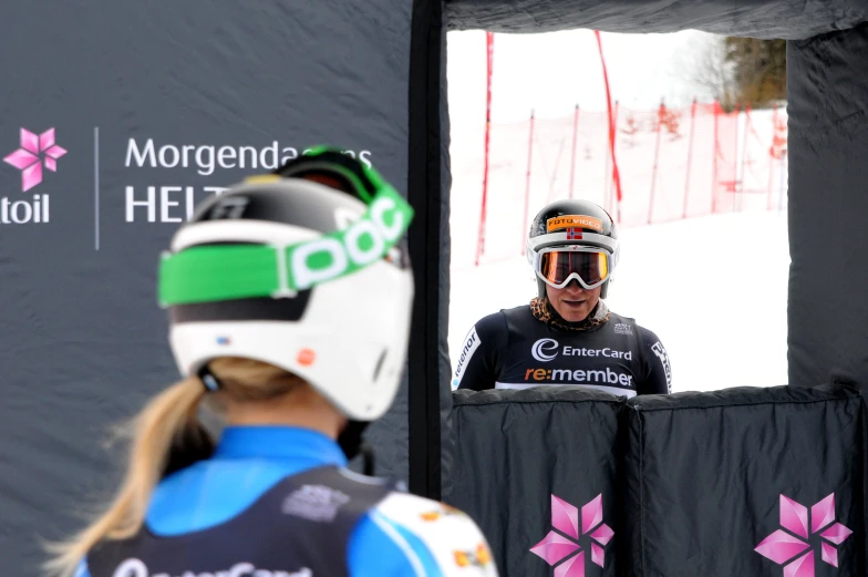 a woman with ski gear speaking from a podium