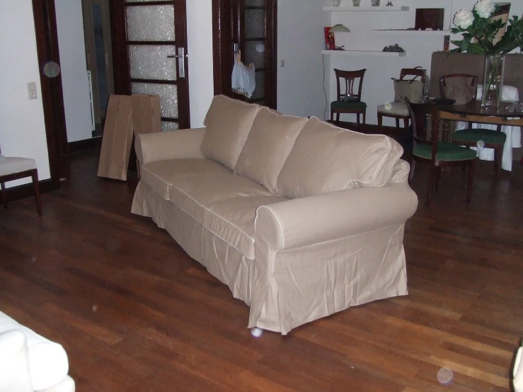 a living room filled with furniture next to a dining room table