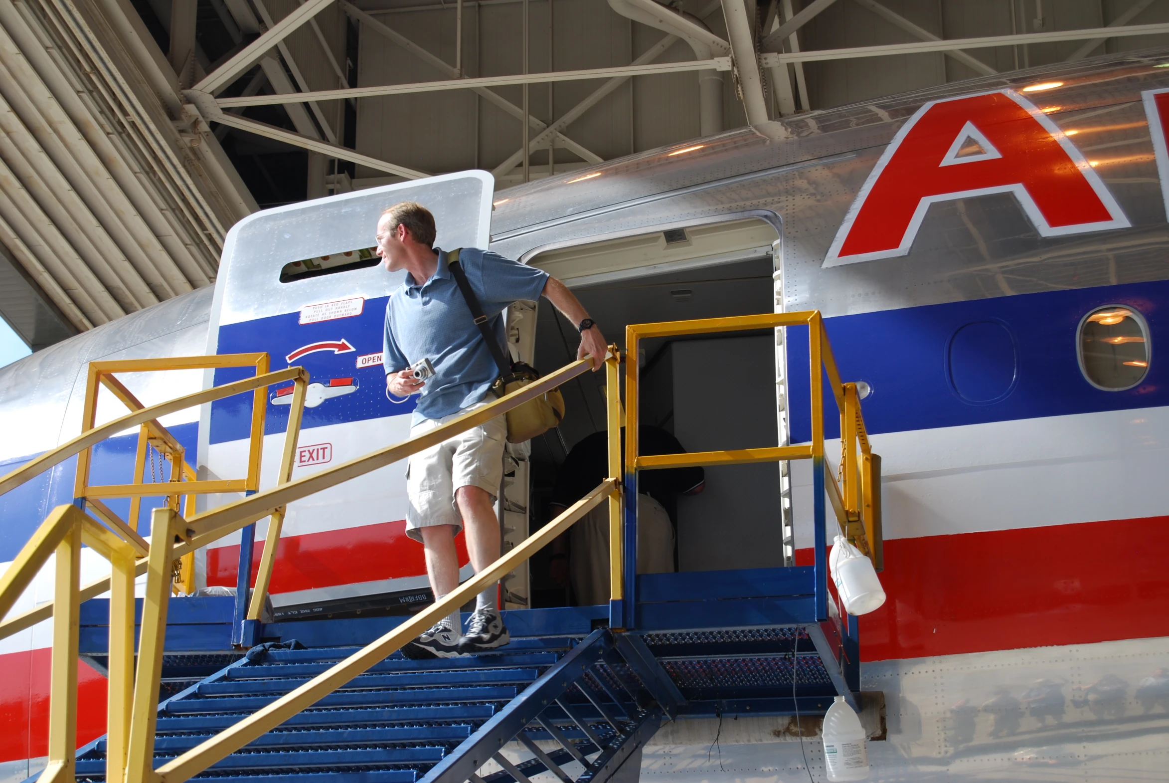 a man is standing on a ramp next to a airplane