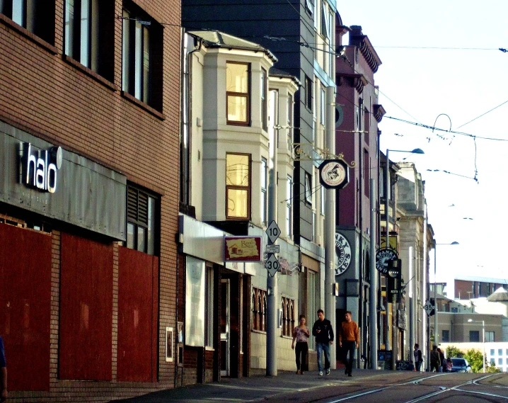 the pedestrians are walking down a street in the city