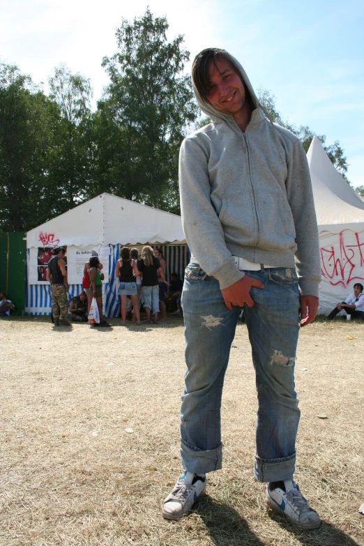 a woman is standing in the dirt with her hands on her hips