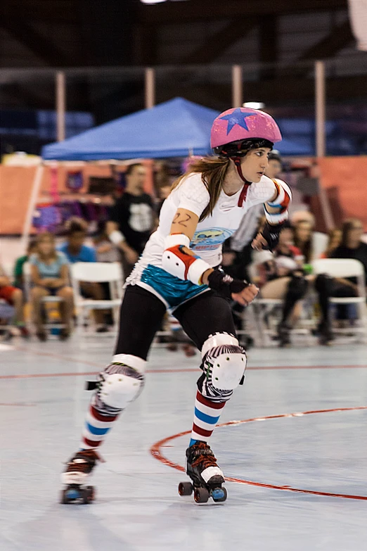 a girl in rollerskard stance on the court