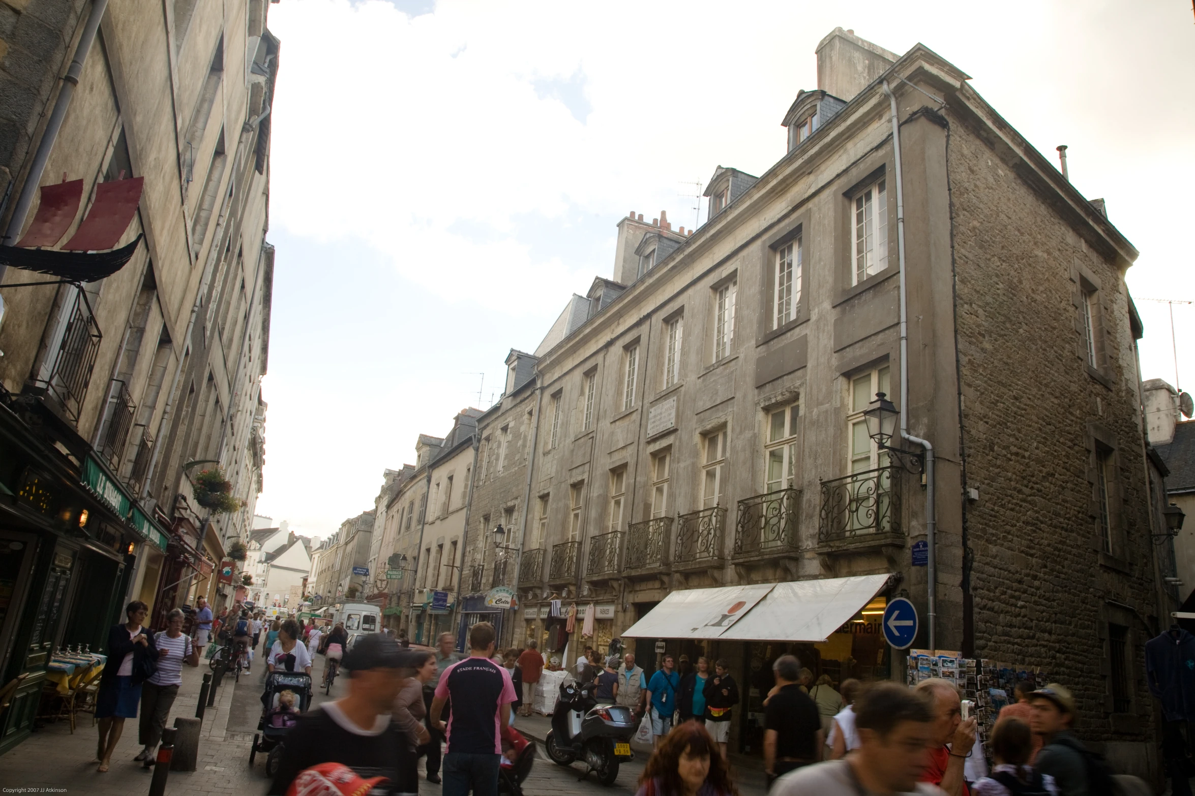 a large group of people walking along a street