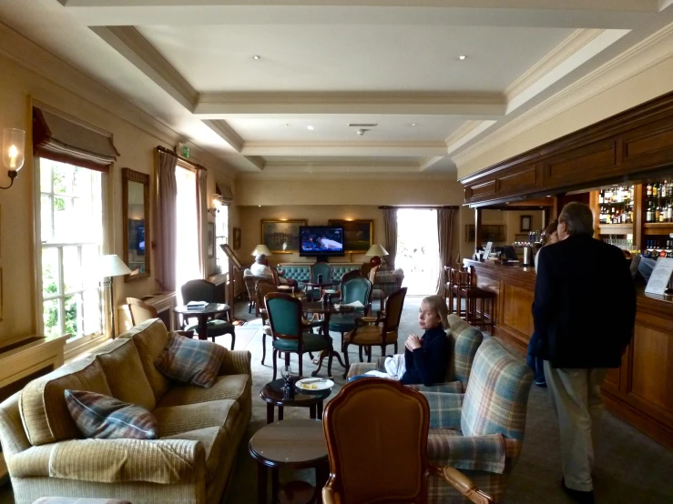 a restaurant bar with some people standing around