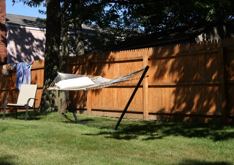 a hammock and chair in the back yard