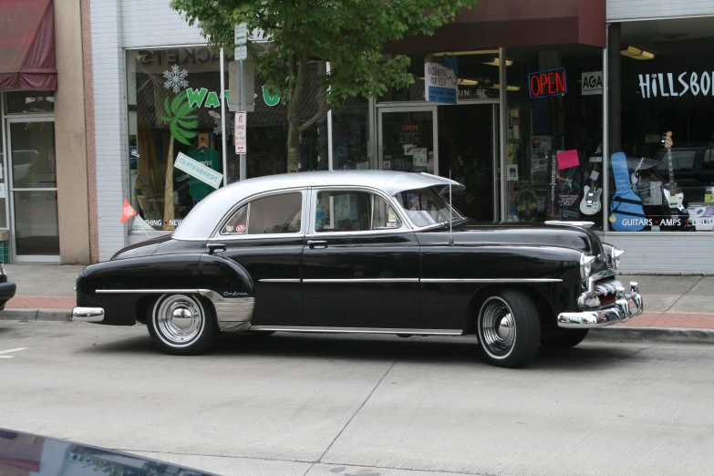 an old car in front of a store