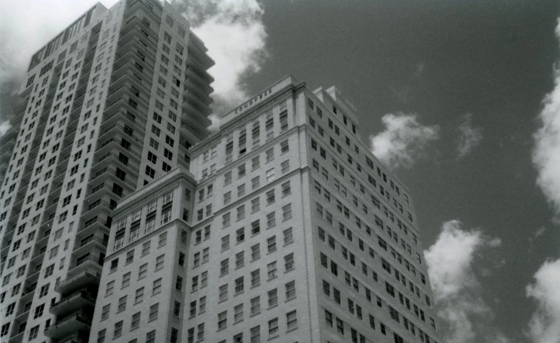 looking up at the side of two large white building