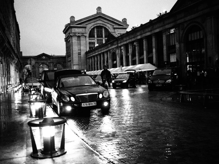 cars parked on a street at night with dark skies