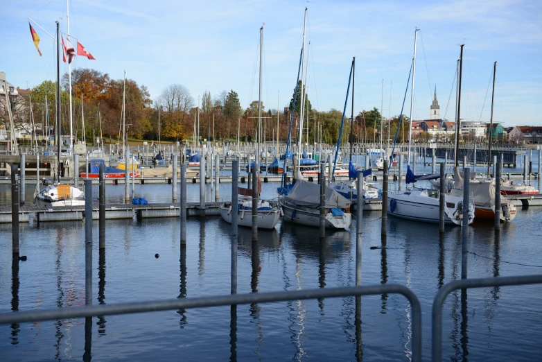 small boats are moored in a harbor near buildings