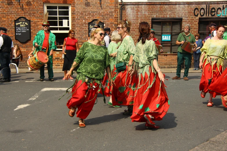 people dressed in ethnic style walking along side each other