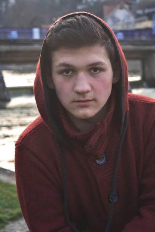 a boy in a red sweatshirt with a hoody