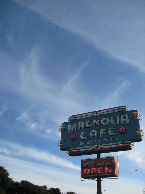 a street sign and sign for the macaroni cafe