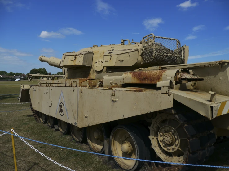 a brown tank that is next to a fence