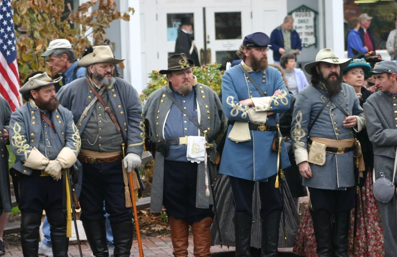 the group of men are dressed in colonial era costumes