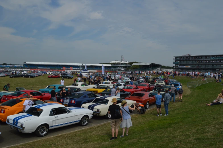 an array of classic race cars parked at a carnival