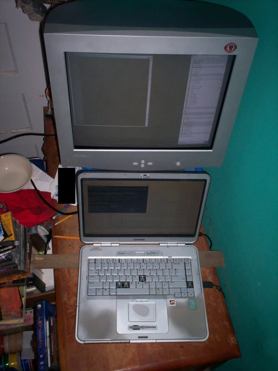 a laptop computer on top of a wooden desk