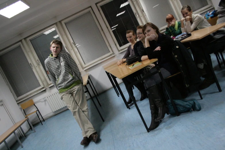 a group of people sitting at desks working on computer