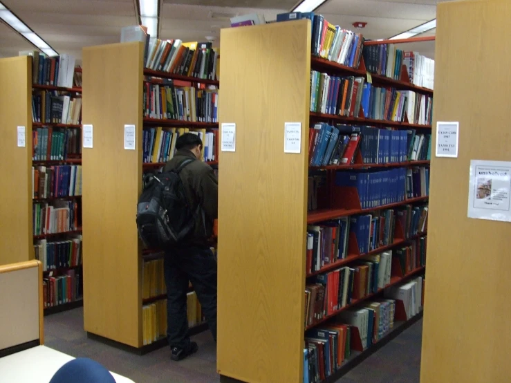 a room full of books with three tall cabinets