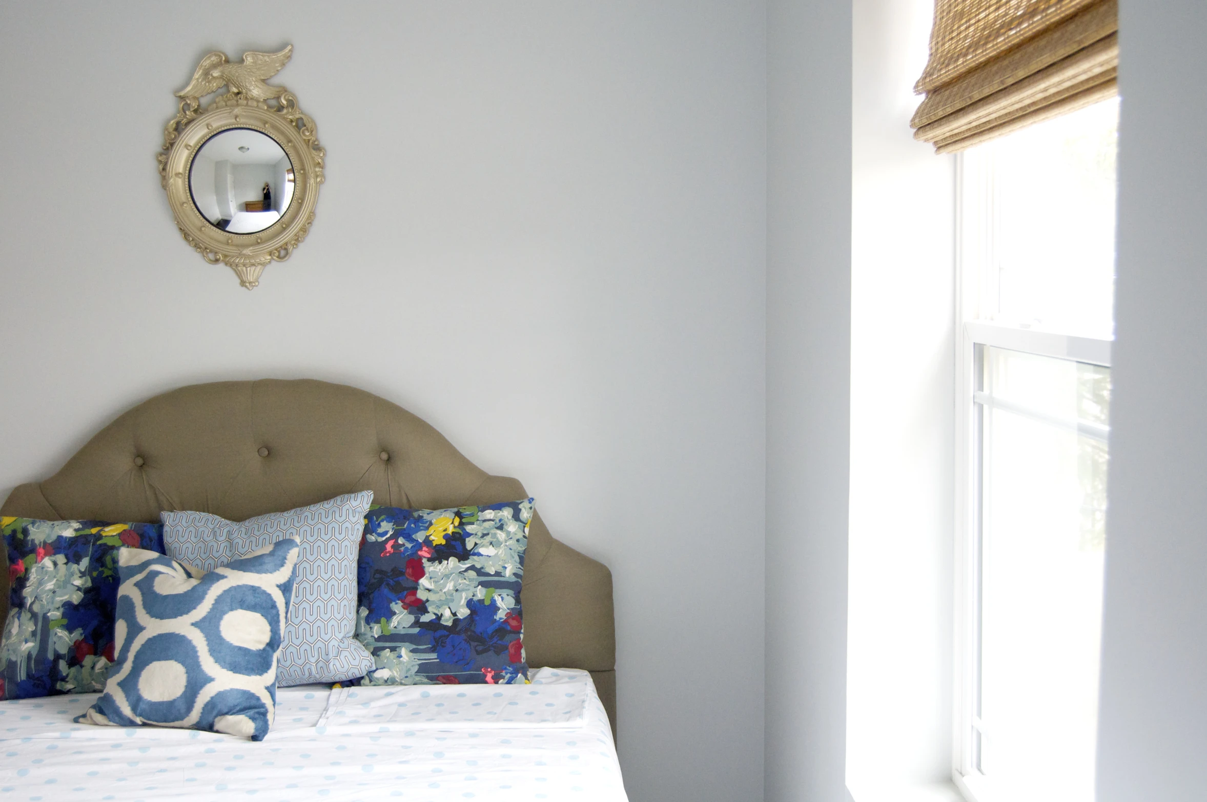 the bedroom features blue pillows and white walls