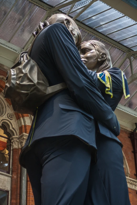 a statue of two people emcing each other