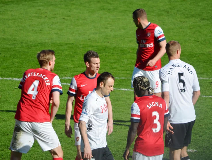 the soccer players are meeting with one another