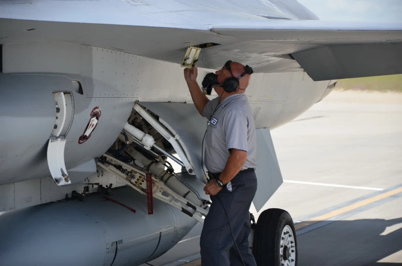 an image of a person working on an airplane