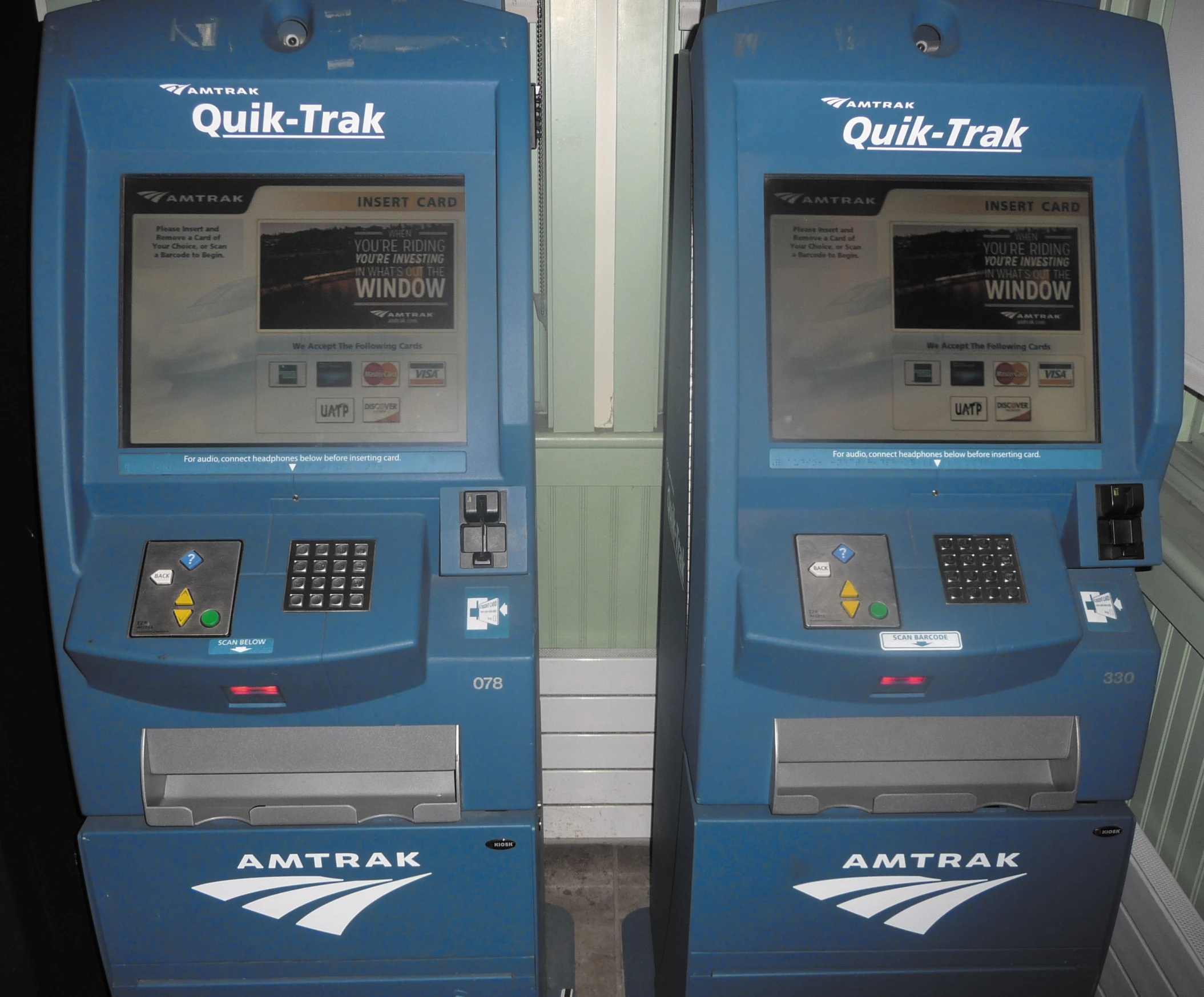 two atms with electronic terminals in an airport