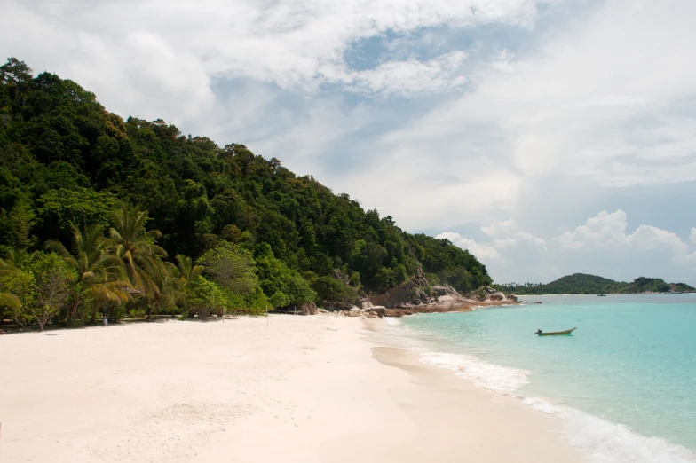 a boat on the beach near an ocean