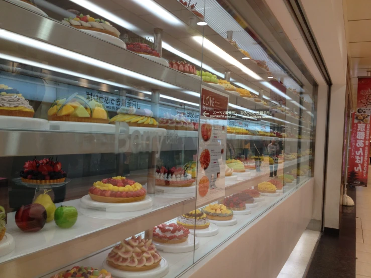 an assortment of deserts are displayed in a store