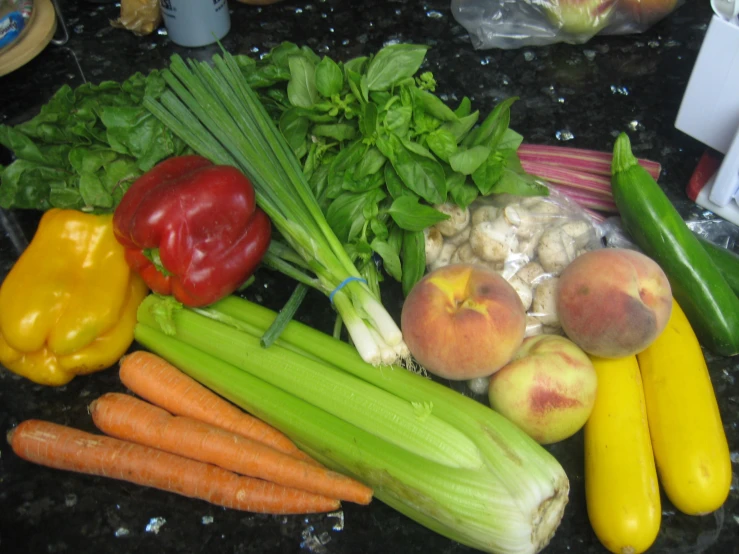 various vegetables with herbs are displayed on a counter