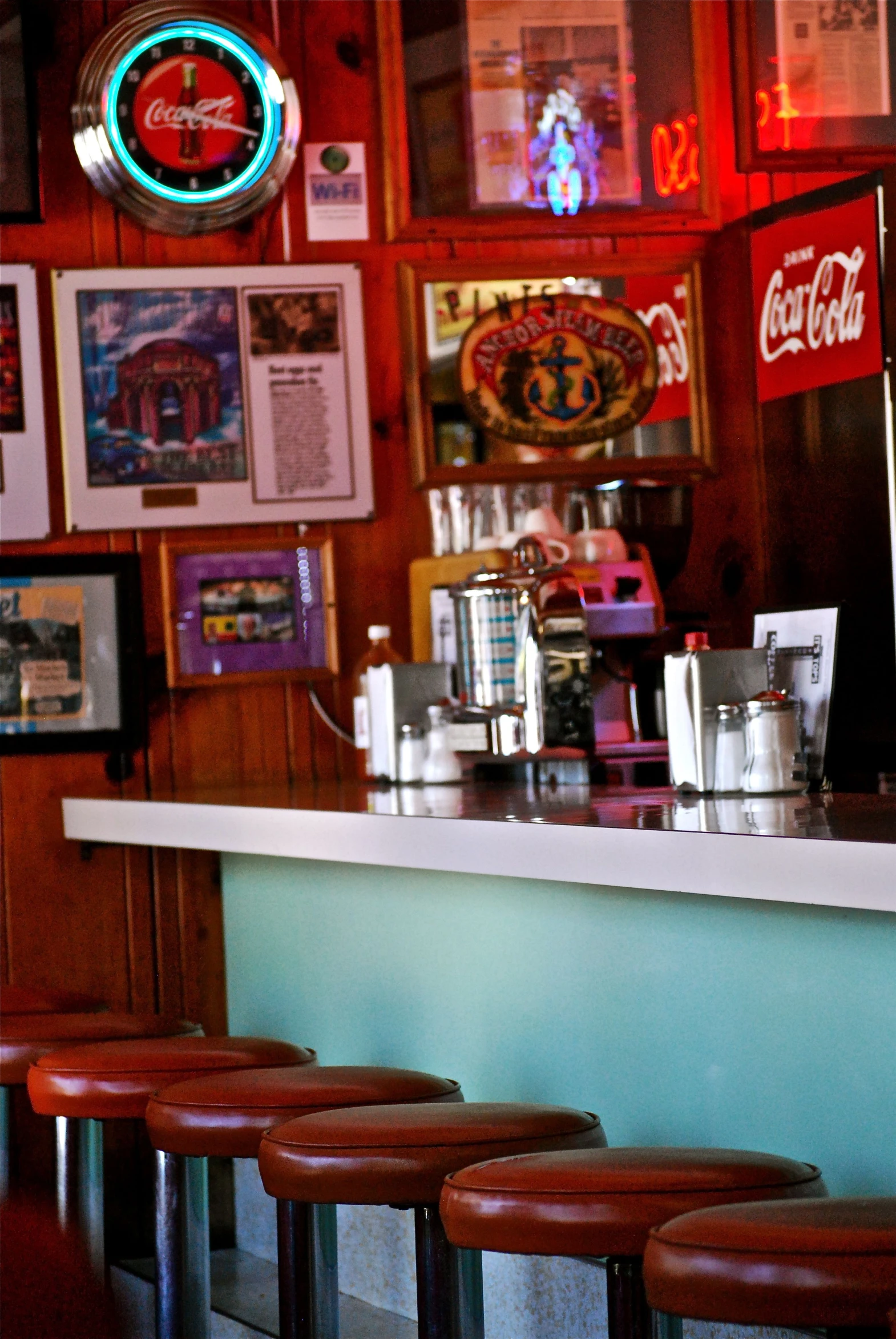 a counter top in a room that is decorated with pictures and signs