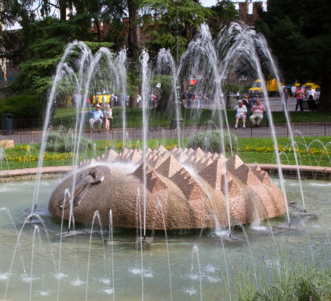 a sculpture made out of an animal has water gushing its eyes