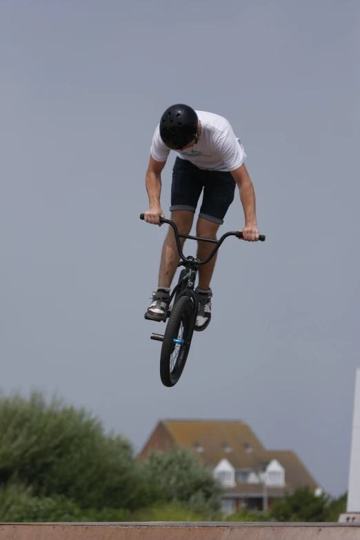 a man is doing a jump on a bicycle