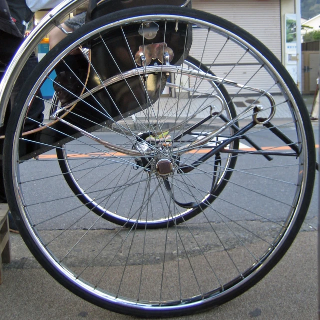 a broken wheel sitting on top of a metal cart