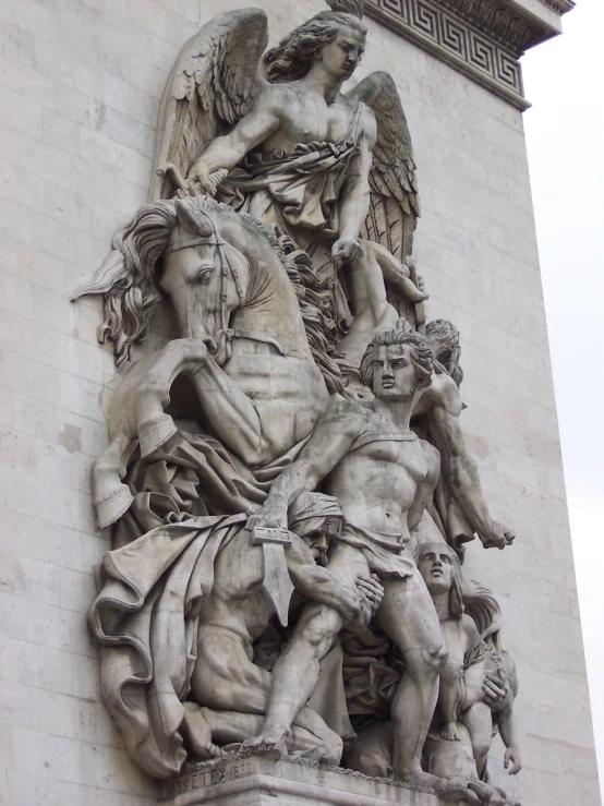 the image shows a very detailed statue outside of a building