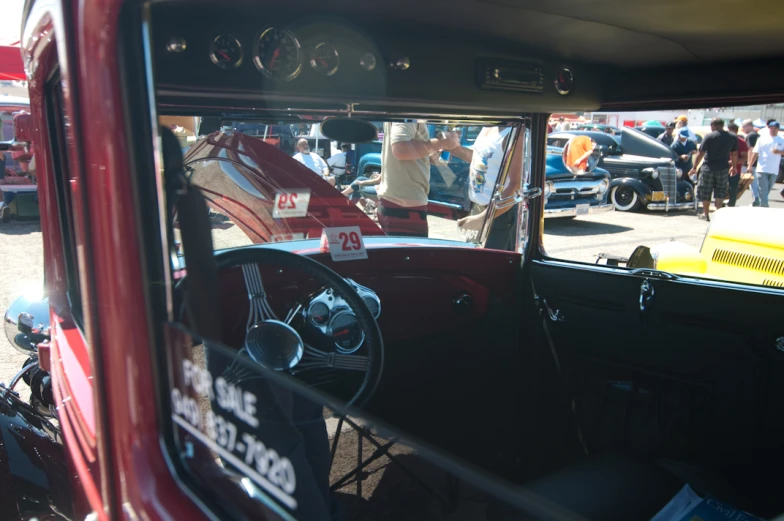 a man in a classic car is shown from a car mirror