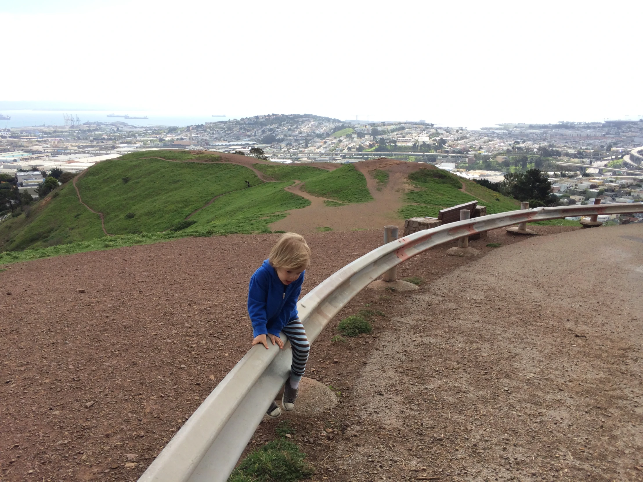 a  standing on top of a cement wall