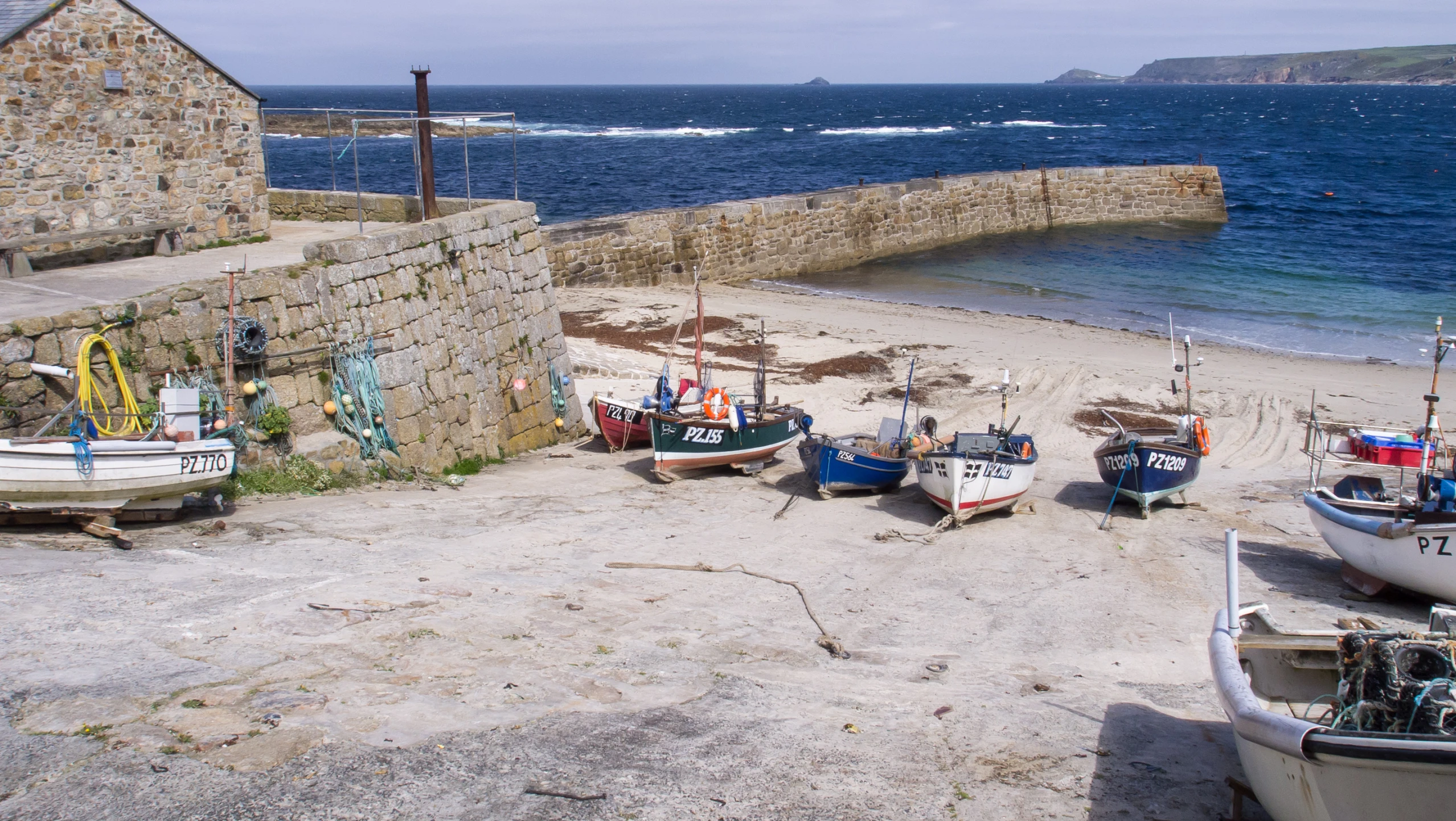 four boats parked in front of an old pier